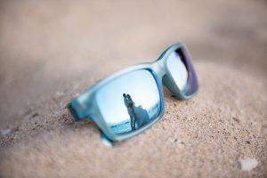 reflection of couple through sunglass